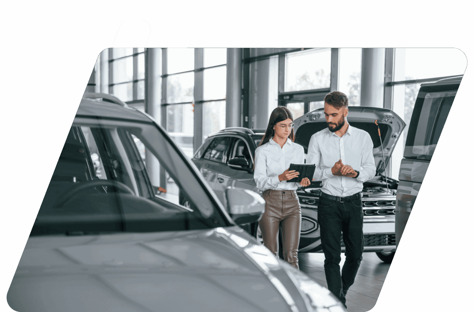 Car showroom with two people discussing.